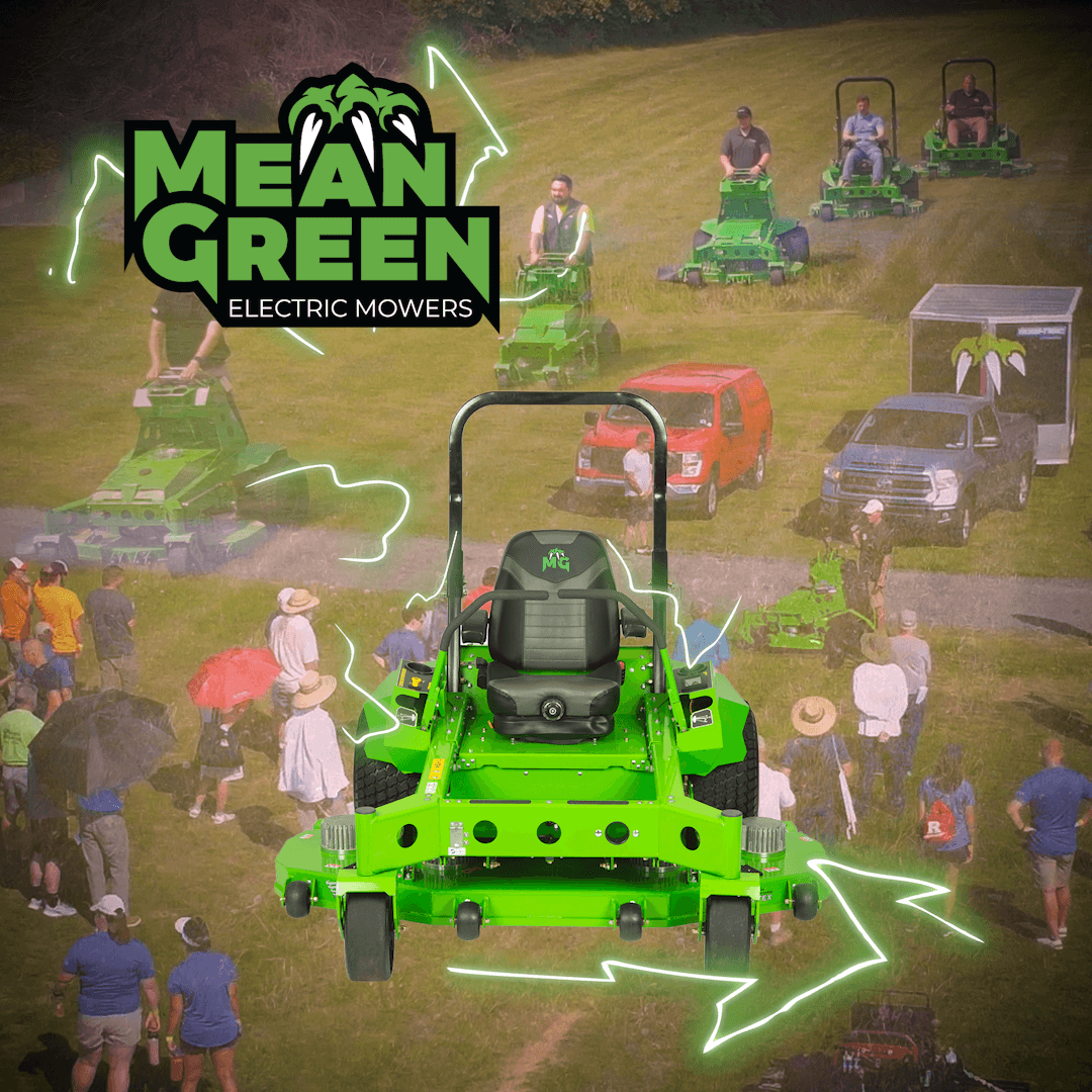 Mean Green Electric Mowers zero-turn mower in front of a crowd at a field demo